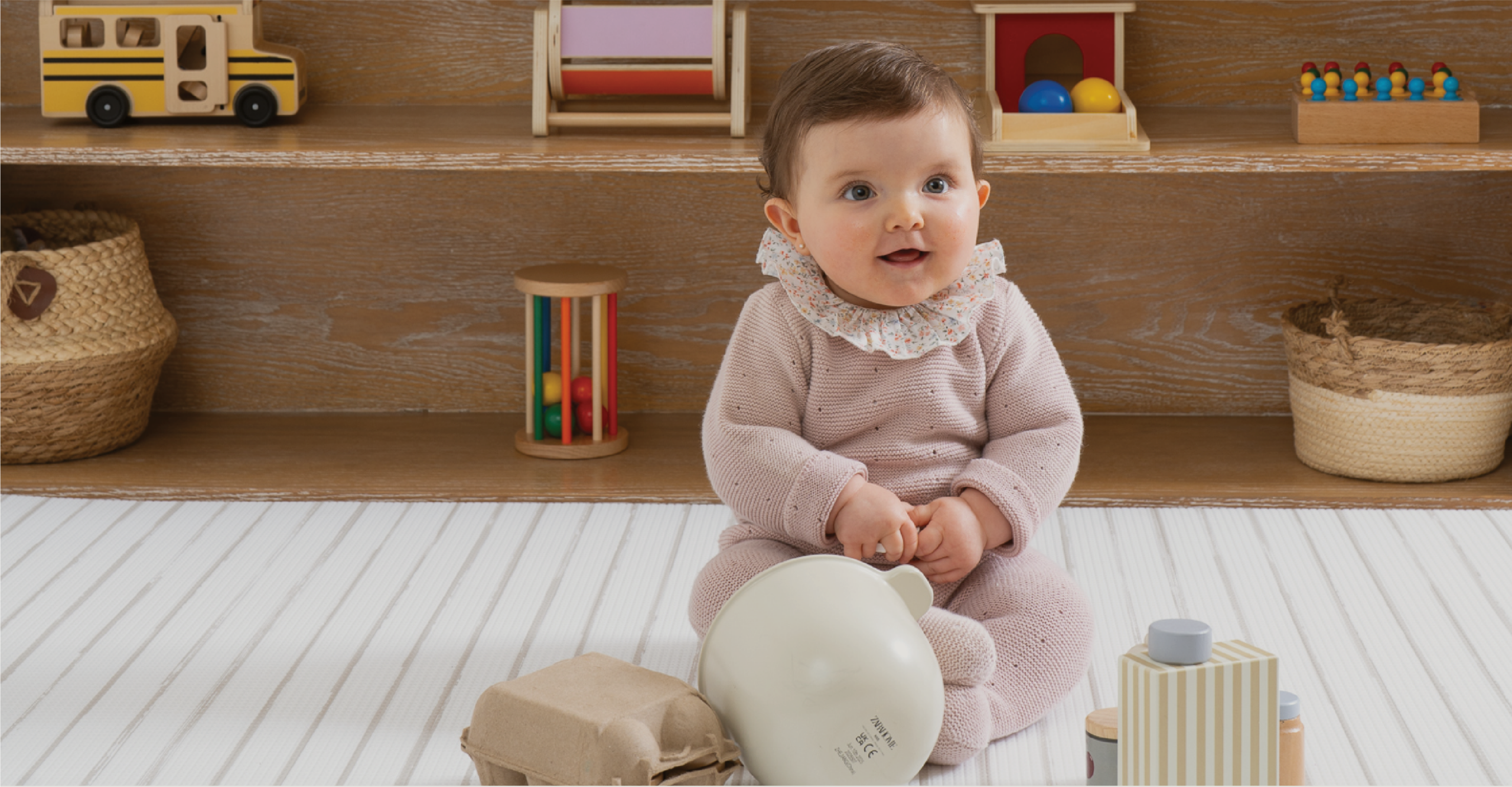 Bebé sobre un playmat Pippa & Co.